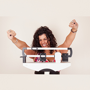 Happy,Woman,Celebrating,Her,Weight,Loss,On,A,Medical,Weight
